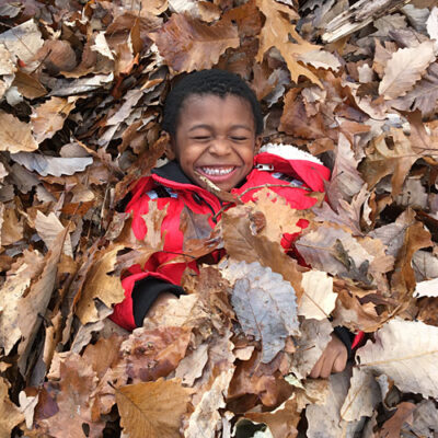Outdoor Learning Resources - boy in leaves